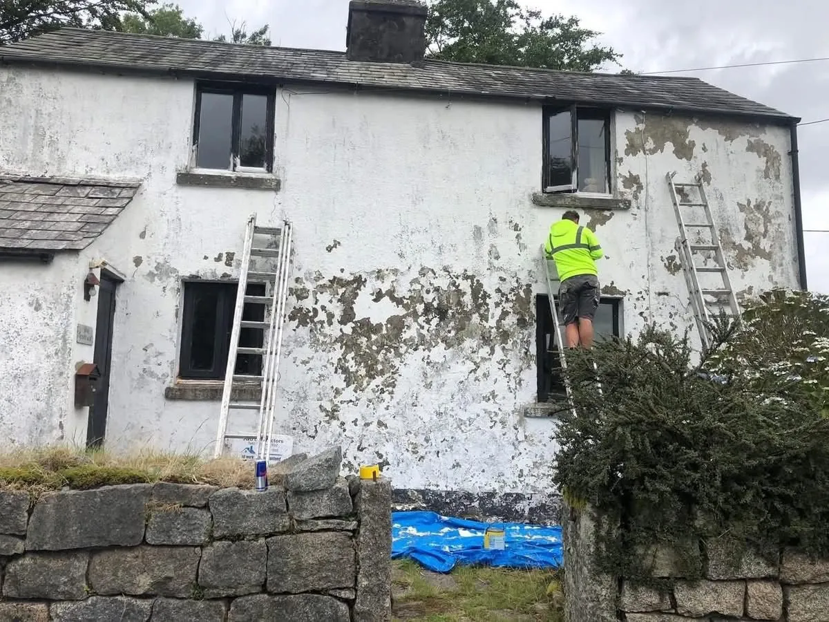 Cottage with blown, flaking render before repair in Saltash